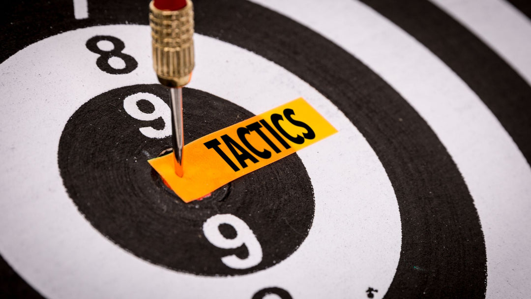 Dart board with the word tactics on orange fabric  in Bulls eye